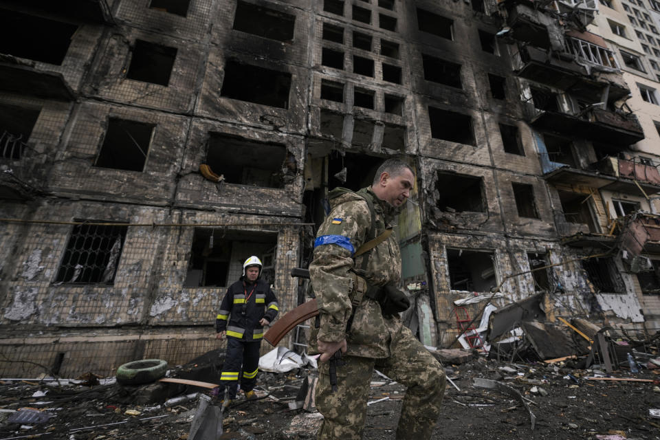 FILE - Ukrainian soldiers and firefighters search in a destroyed building after a bombing attack in Kyiv, Ukraine, Monday, March 14, 2022. (AP Photo/Vadim Ghirda, File)