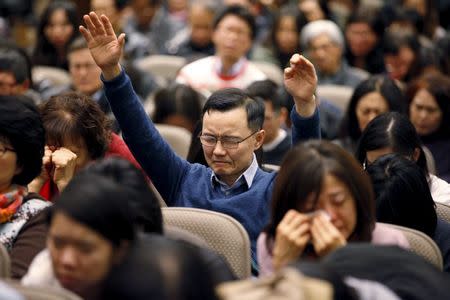 Jae Sun Lee of North York raises his hands while praying for Canadian pastor Hyeon Soo Lim who is being held in North Korea during a joint multi-cultural prayer meeting at Light Korean Presbyterian Church in Toronto, December 20, 2015. REUTERS/Hyungwon Kang