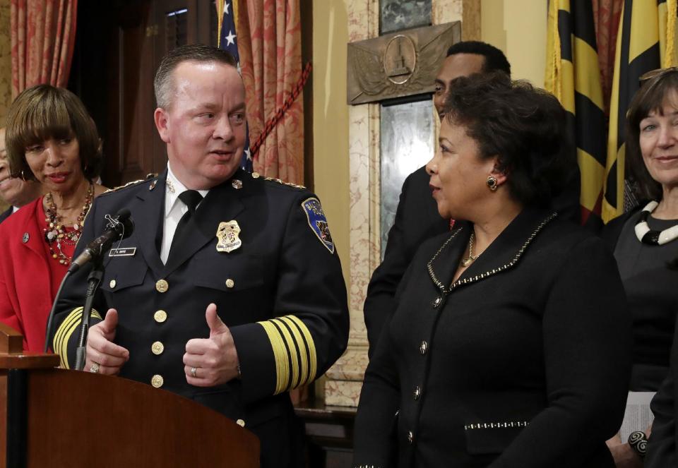 Baltimore Police Department Commissioner Kevin Davis, left, gives a thumbs up to Attorney General Loretta Lynch during a joint news conference in Baltimore, Thursday, Jan. 12, 2017, to announce his department's commitment to a sweeping overhaul of its practices under a court-enforceable agreement with the federal government. (AP Photo/Patrick Semansky)