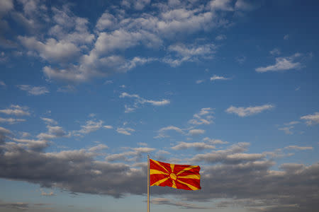 FILE PHOTO: A Macedonian flag flutters on one day before the referendum on changing the country's name that would open the way for it to join NATO and the European Union, in Skopje, Macedonia September 29, 2018. REUTERS/Marko Djurica/File Photo