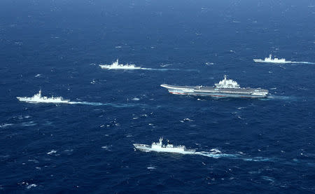 FILE PHOTO: China's Liaoning aircraft carrier with accompanying fleet conducts a drill in an area of South China Sea in this undated photo taken December, 2016. REUTERS/Stringer/File Photo