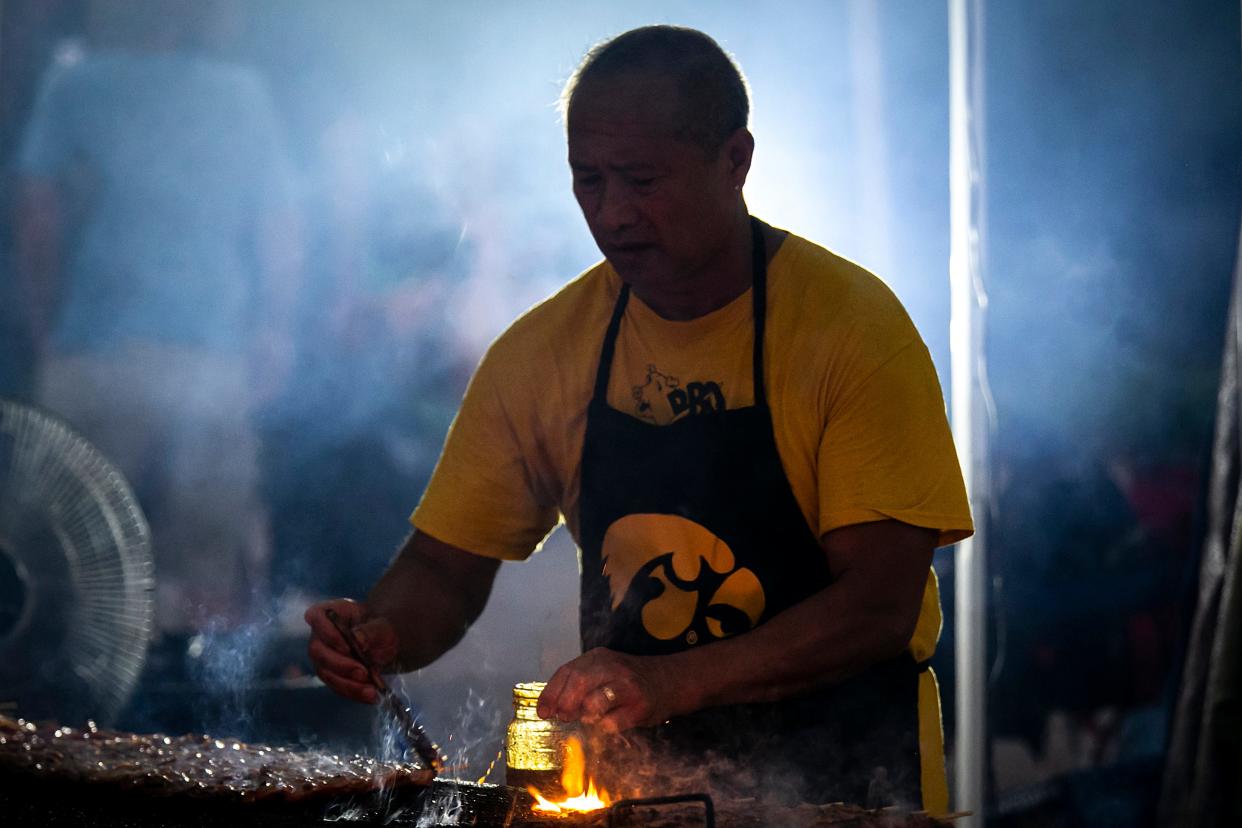 Tolen Forte of Yolanda's BBQ prepares food during Iowa City Jazz Festival, Saturday, July 1, 2023, in Iowa City, Iowa.