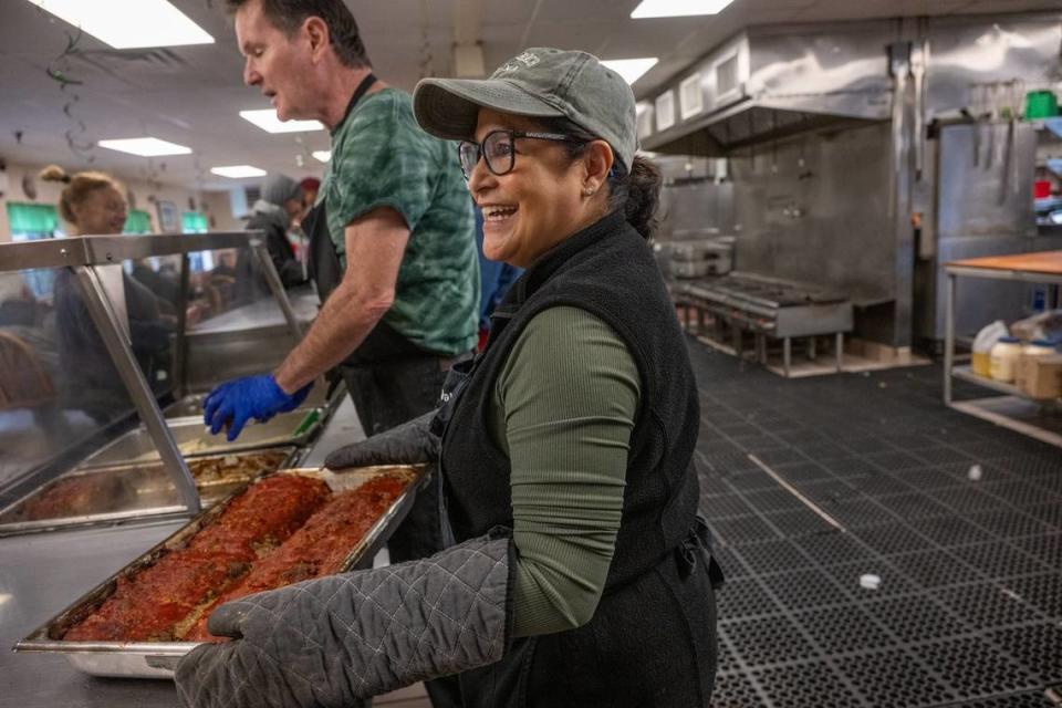 Loaves & Fishes volunteer Ja’net Blea gets ready to serve meatloaf for lunch last week in Sacramento. The organization currently lacks dedicated funding for the new kitchen equipment and is asking Book of Dreams to help them purchase new stoves.