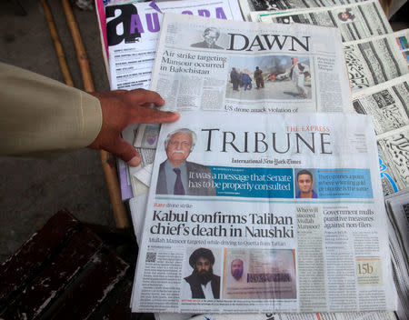 Newspapers containing news about Afghan Taliban leader Mullah Akhtar Mansour are on display at a stall in Peshawar, Pakistan, May 23, 2016. REUTERS/Fayaz Aziz