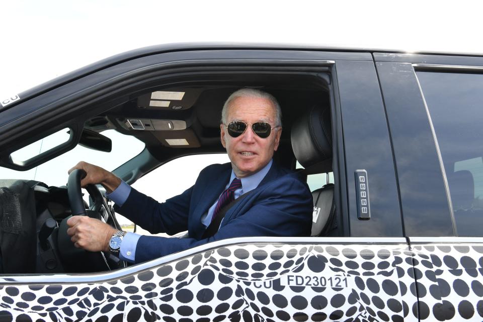 TOPSHOT - US President Joe Biden drives the new electric Ford F-150 Lightning at the Ford Dearborn Development Center in Dearborn, Michigan on May 18, 2021. (Photo by Nicholas Kamm / AFP) (Photo by NICHOLAS KAMM/AFP via Getty Images)