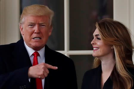 FILE PHOTO: U.S. President Trump reacts as he stands next to former White House Communications Director Hope Hicks outside of the Oval Office as he departs for a trip to Cleveland, Ohio, in Washington D.C.