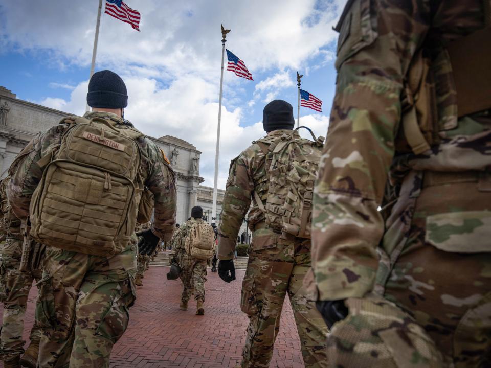 <p>Members of the National Guard march by Union Station during the inauguration of Joe Biden as US President in Washington, DC, on 20 January 2021</p> ((EPA))