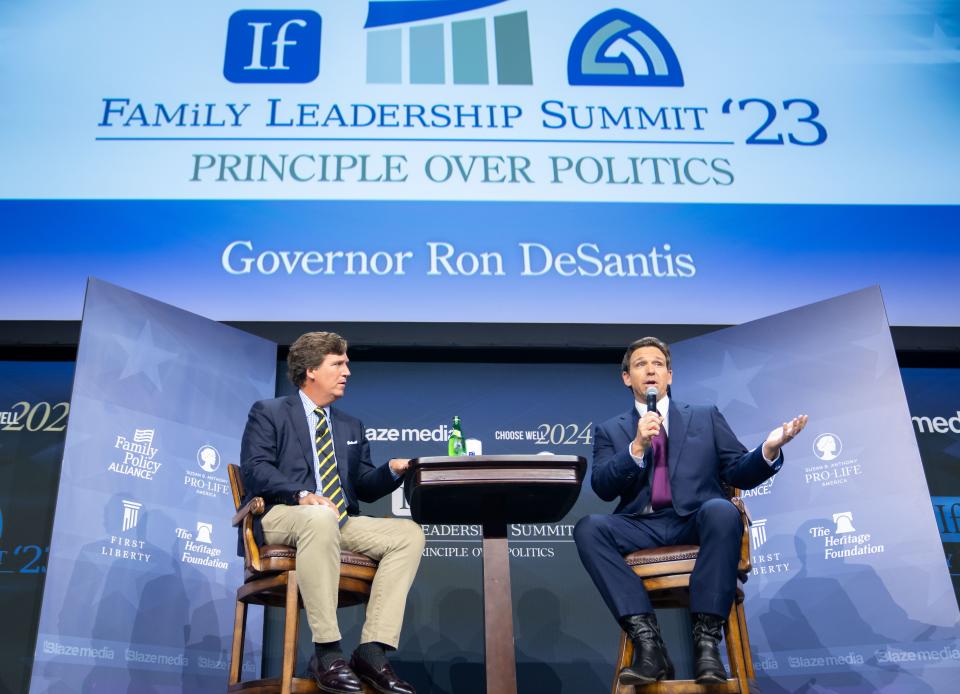 Republican presidential candidate and Florida Gov. Ron DeSantis talks with moderator Tucker Carlson, left, during the Family Leadership Summit in Des Moines, Friday, July 14, 2023. 