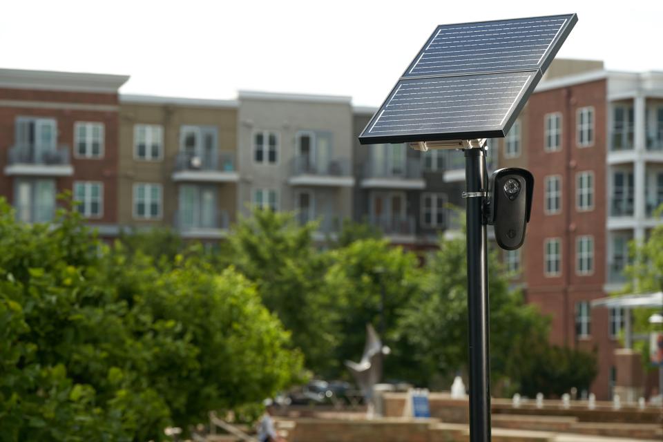 Flock safety cameras on a pole with a solar panel, which powers the license plate reader.