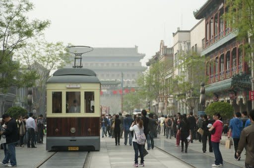 Visitors walk past newly built "heritage" buildings in Beijing's historical Qianmen street. The landscape is so changed that even though China has excelled at copying for centuries, Beijingers have lined up to rail against the "fake antiquities" project