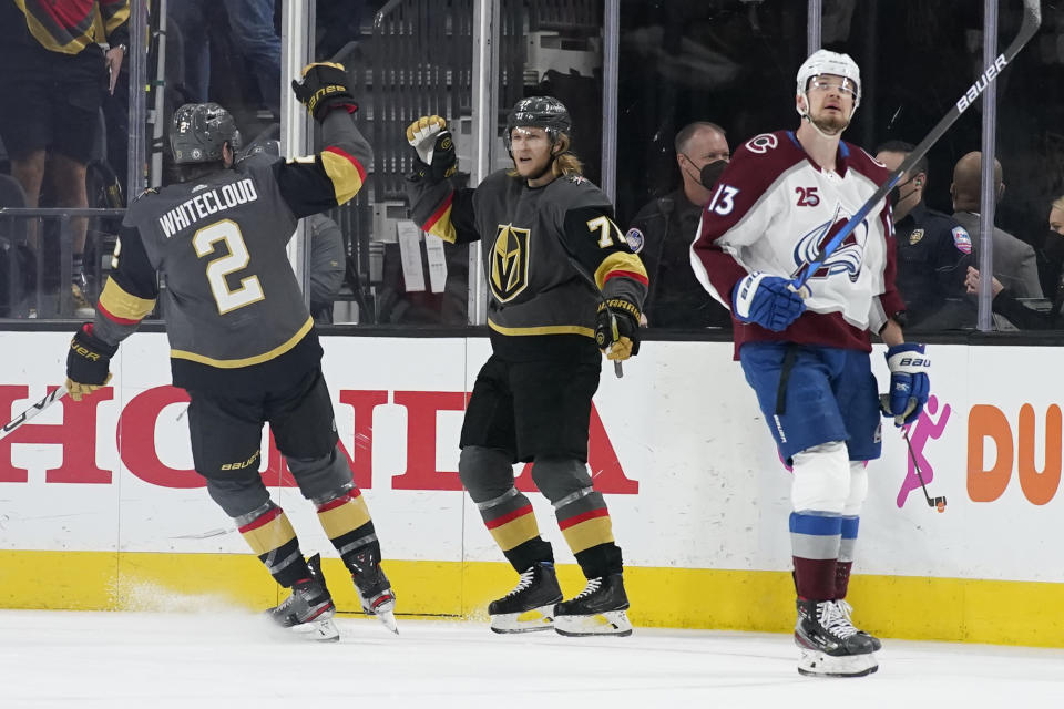 Vegas Golden Knights defenseman Zach Whitecloud (2) celebrates after center William Karlsson (71) scored a goal against the Colorado Avalanche during the first period in Game 6 of an NHL hockey Stanley Cup second-round playoff series Thursday, June 10, 2021, in Las Vegas. (AP Photo/John Locher)