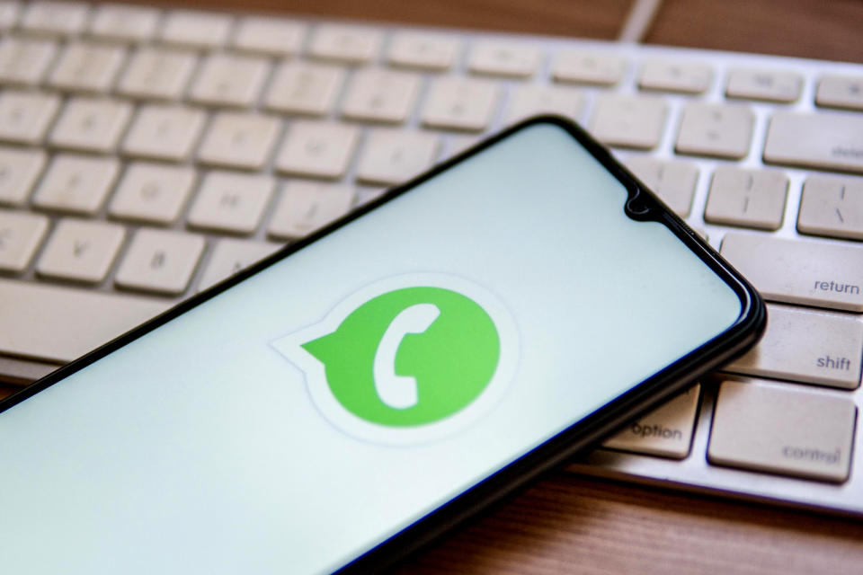 SPAIN - 2022/04/25: In this photo illustration, a WhatsApp logo seen displayed on a smartphone on top of a computer keyboard. (Photo Illustration by Thiago Prudencio/SOPA Images/LightRocket via Getty Images)