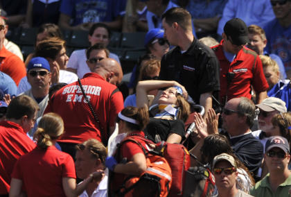 A fan is carried away after being hit by a line-drive foul ball at Wrigley Field. (AP)