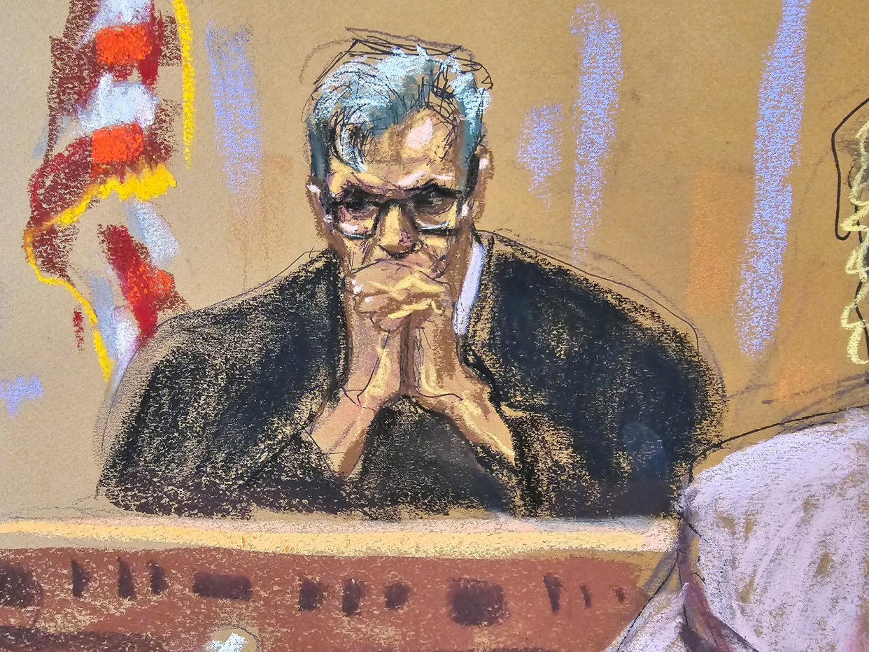 In a courtroom sketch, New York Supreme Court Judge Juan Merchan, hands clasped in front of him, listens as Stormy Daniels testifies.