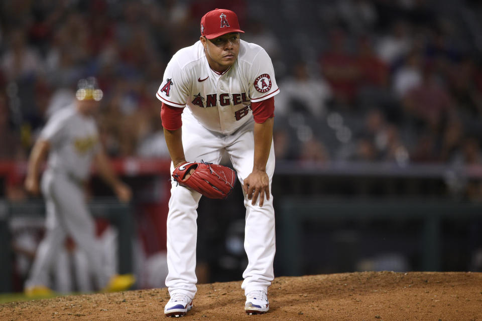 Los Angeles Angels relief pitcher Jose Quintana reacts after a throwing error on a pickoff attempt to first base resulting in a run scored by Oakland Athletics' Elvis Andrus during the seventh inning of a baseball game in Anaheim, Calif., Thursday, July 29, 2021. (AP Photo/Kelvin Kuo)