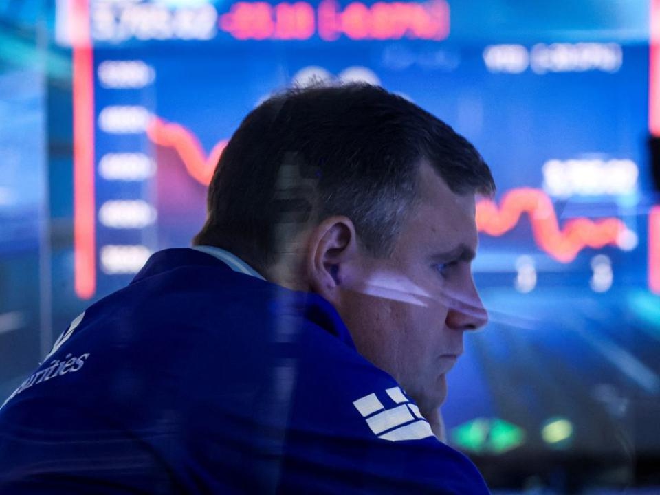 Traders work on the floor of the NYSE in New York