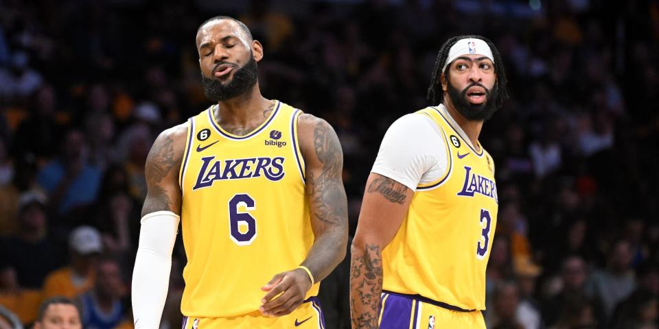 LeBron James shuts his eyes and reacts during a game as Anthony Davis looks on behind him.