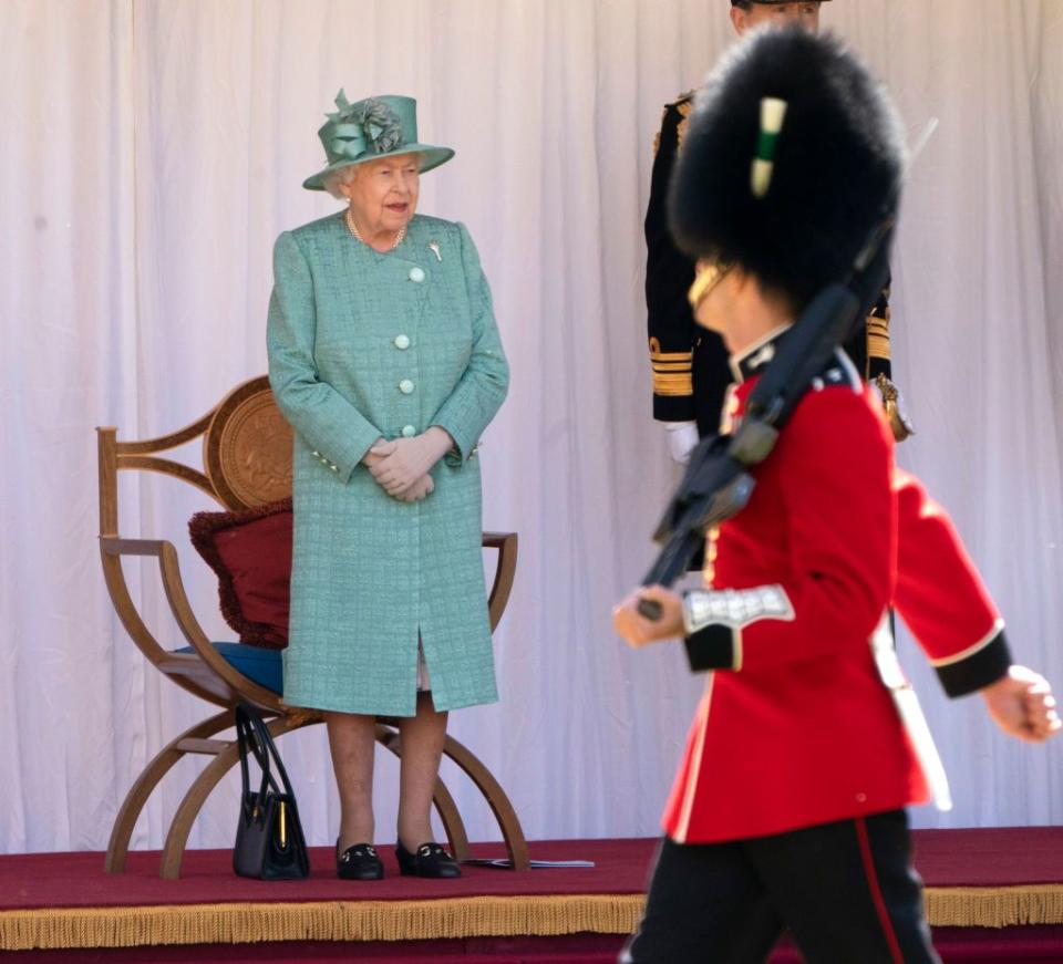 Queen Elizabeth watches the ceremony.