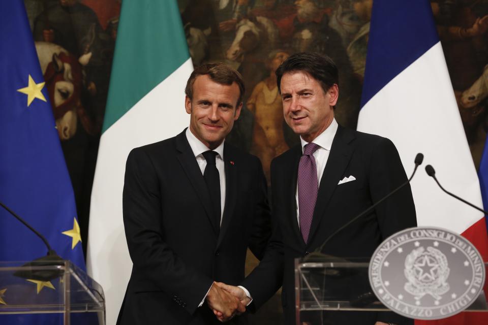 FILE - In this Wednesday, Sept. 18, 2019 file photo, French President Emmanuel Macron and Italian Premier Giuseppe Conte pose as they meet the media at Chigi Palace Premier office in Rome. When Giuseppe Conte exited the premier’s office, palace employees warmly applauded in him appreciation. But that’s hardly likely to be Conte’s last hurrah in politics. Just a few hours after the handover-ceremony to transfer power to Mario Draghi, the former European Central Bank chief now tasked with leading Italy in the pandemic, Conte dashed off a thank-you note to citizens that sounded more like an ’’arrivederci″ (see you again) then a retreat from the political world he was unexpectedly propelled into in 2018.(AP Photo/Domenico Stinellis, File)