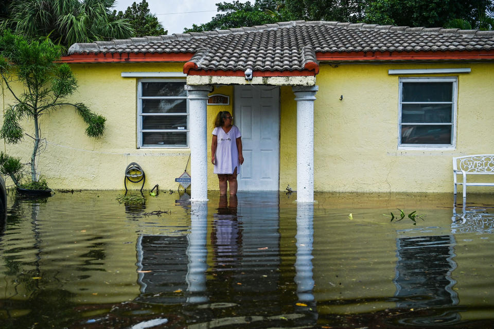 A woman looks on as she stands outside of a flooded home after heavy rain in Fort Lauderdale, Fla., on April 13, 2023.<span class="copyright">Chandan Khanna—AFP/Getty Images</span>