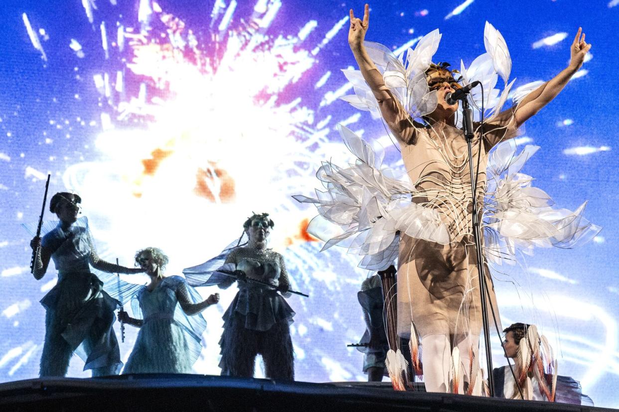 A woman onstage in front of a string section.