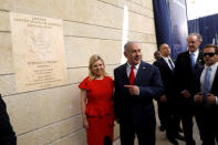 FILE PHOTO: Israeli Prime Minister Benjamin Netanyahu and his wife Sara Netanyahu stand next to the dedication plaque of the U.S. embassy in Jerusalem, after the dedication ceremony of the new U.S. embassy in Jerusalem, May 14, 2018. REUTERS/Ronen Zvulun/File Photo