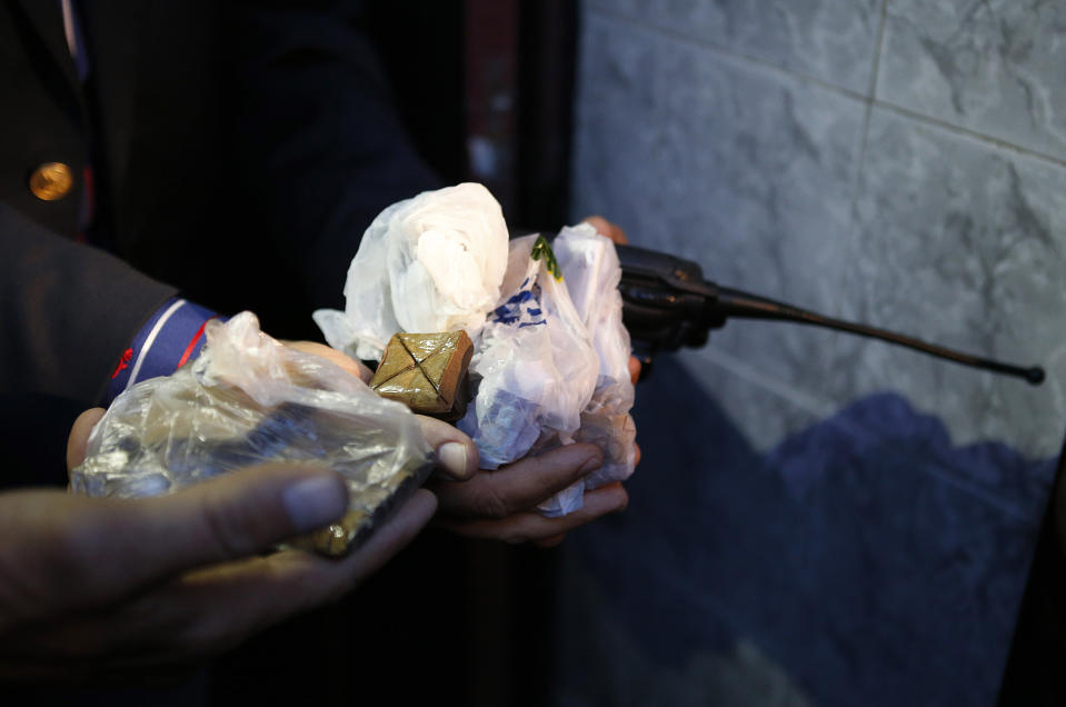 This Wednesday April 30, 2014 photo shows a Moroccan police officer showing drugs in possession of a dealer, after his arrest in Casablanca, Morocco. As home to most of Morocco’s economy, as well as most its slums, Casablanca in particular has always had a crime problem. It is a city of extremes, with skyscrapers and highend nightlife on one hand and the other the crushing poverty that spawned the angry youth who killed 33 people in a spate of bombings in 2003.(AP Photo / Abdeljalil Bounhar)