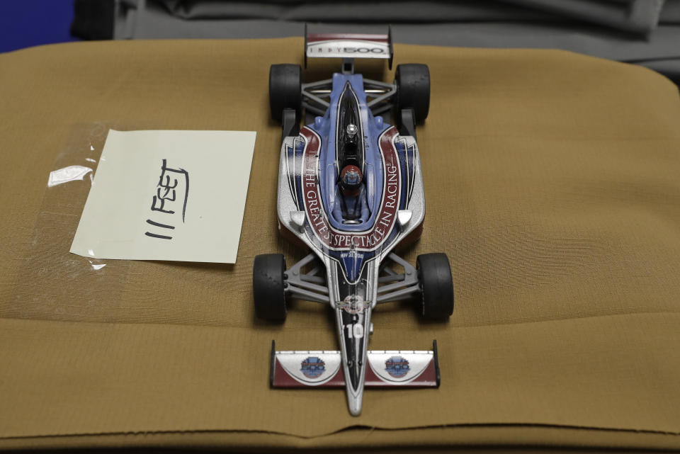 A model of an IndyCar sits on material in the Dallara USA factory, Wednesday, April 15, 2020, in Indianapolis. The factory is cutting out material patterns for protective medical gowns during the coronavirus pandemic. (AP Photo/Darron Cummings)