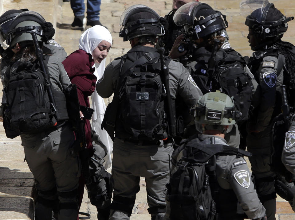 Israeli police arrests a Palestinian woman during clashes between Israeli security forces and Palestinian protesters in Jerusalem's Old City, Tuesday, May 18, 2021. (AP Photo/Mahmoud Illean)