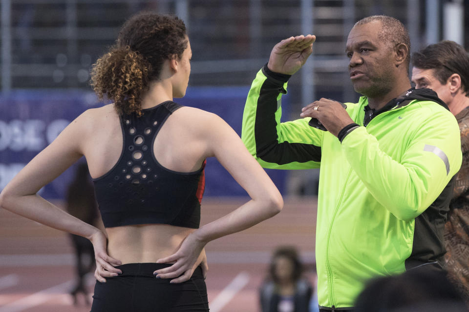 Former NFL quarterback Randall Cunningham, right, gives his daughter Vashti instruction while she competes in the Women's John Thomas High Jump competition at the Millrose Games track and field meet, Saturday, Feb. 9, 2019, in New York. (AP Photo/Mary Altaffer)