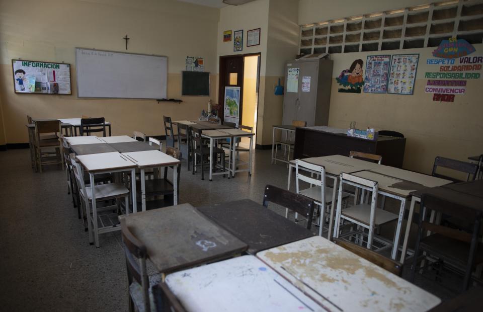 A classroom stands empty at the Fe y Alegria school in Caracas, Venezuela, Tuesday, April 28, 2020. Classes have been suspended in Venezuela since March 13, due to the quarantine decreed to avoid the spread of the new coronavirus. (AP Photo/Ariana Cubillos)