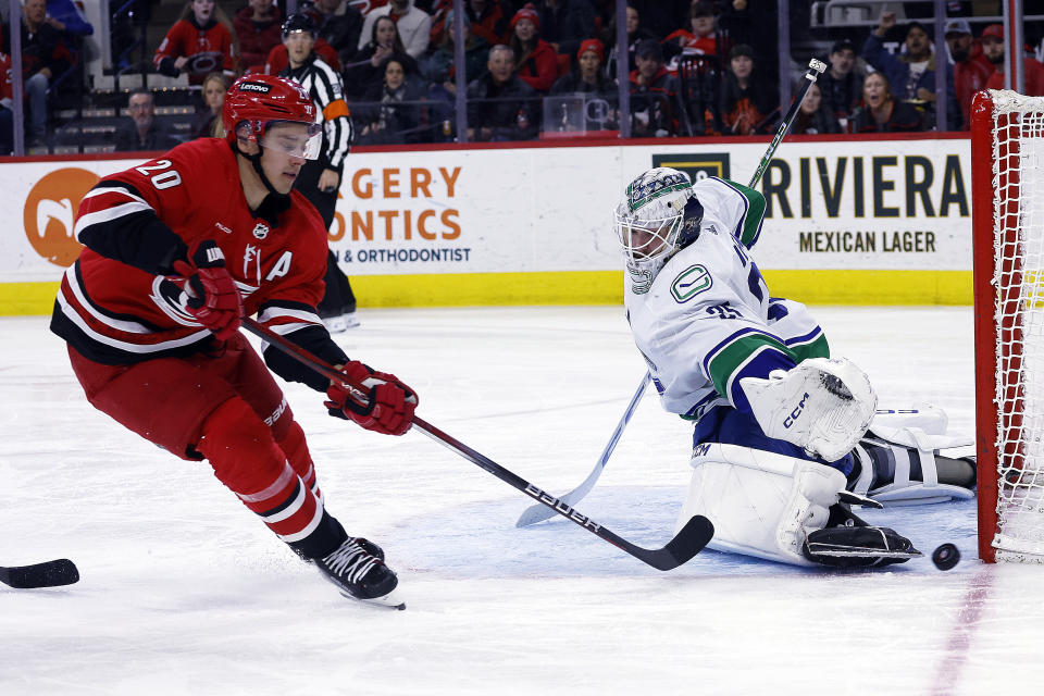 Vancouver Canucks goaltender Thatcher Demko (35) blocks the shot of Carolina Hurricanes' Sebastian Aho (20) during the second period of an NHL hockey game in Raleigh, N.C., Tuesday, Feb. 6, 2024. (AP Photo/Karl B DeBlaker)