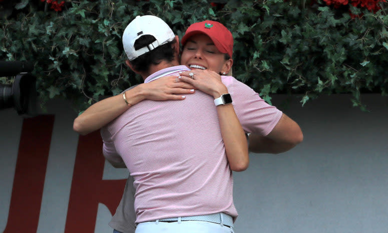 Rory McIlroy celebrates with his wife at the Tour Championship.