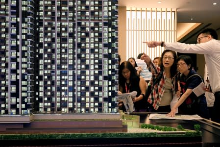 People look at a model of LP6 property development by Nan Fung Group in Hong Kong