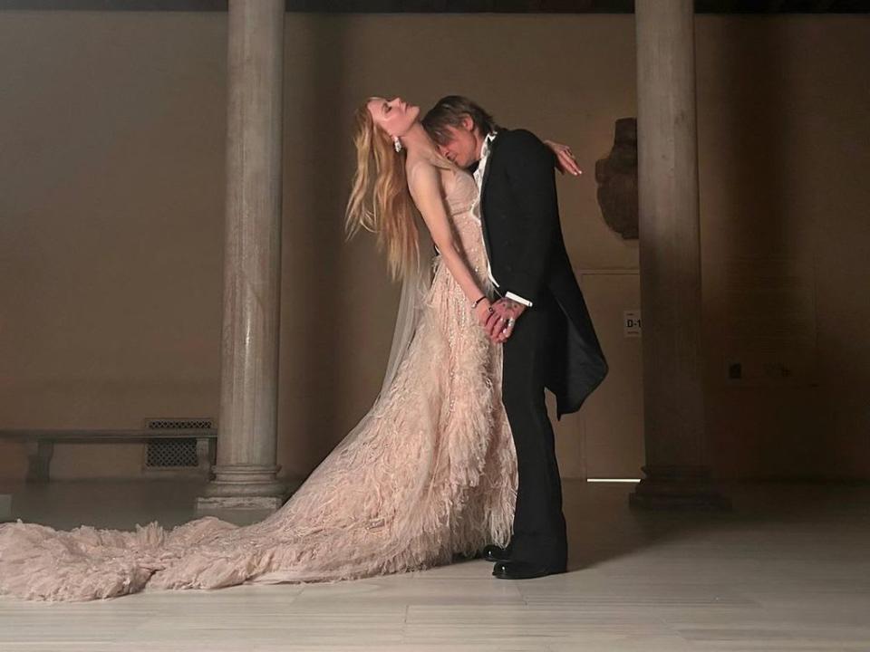 Keith Urban and Nicole Kidman embracing in formal attire