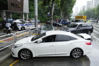 Vehicles, which had been submerged by the heavy rainfall, block a road in Seoul, South Korea, Tuesday, Aug. 9, 2022. Heavy rains drenched South Korea's capital region, turning the streets of Seoul's affluent Gangnam district into a river, leaving submerged vehicles and overwhelming public transport systems. (AP Photo/Ahn Young-joon)