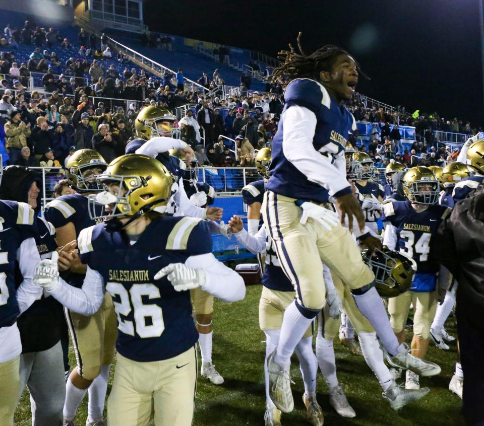 Salesianum's Colin Ford (26) and Jasyn Truitt react in the final moments of Salesianum's 45-17 win against Cape Henlopen in the DIAA Class 3A state tournament final at Delaware Stadium, Friday, Dec. 1, 2023.