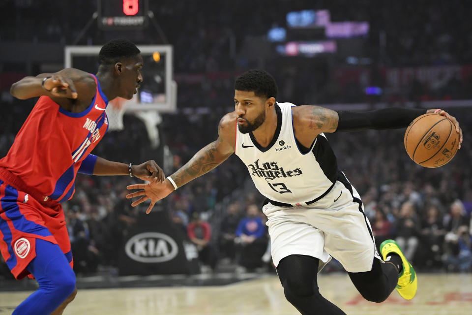 Los Angeles Clippers forward Paul George, right, tries to drive past Detroit Pistons guard Tony Snell during the first half of an NBA basketball game Thursday, Jan. 2, 2020, in Los Angeles. (AP Photo/Mark J. Terrill)