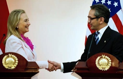 US Secretary of State Hillary Clinton (L) shakes hands with Indonesian Foreign Minister Marty Natalegawa during a joint press conference at the Ministry of Foreign Affairs in Jakarta. Clinton travels to China after sounding an optimistic note in Southeast Asia's largest nation Indonesia