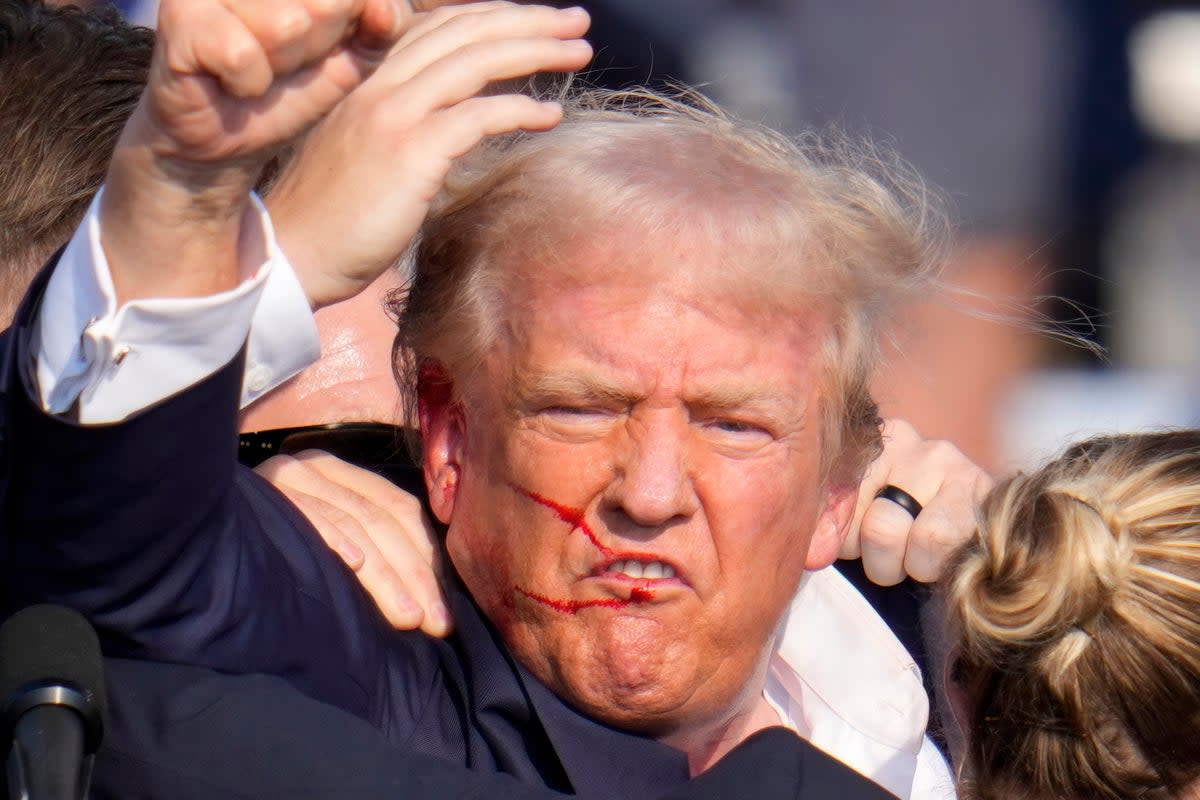 Mr Trump was left bloodied after the shooting