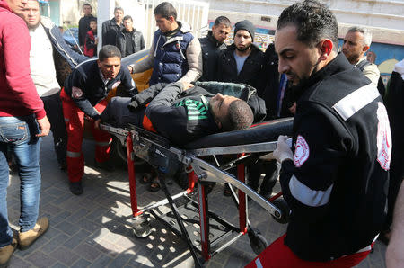 A wounded Palestinian is brought into a hospital following what police said was an Israeli air strike in Rafah in the southern Gaza Strip February 27, 2017. REUTERS/Ibraheem Abu Mustafa