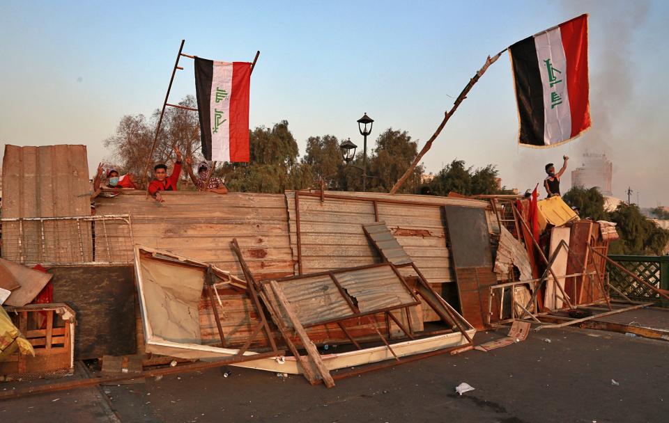 Protesters stage a sit-in on barriers on the Ahrar Bridge, in Baghdad, Iraq, Sunday, Nov. 17, 2019. Protesters retook control of half of Ahrar Bridge, which leads to the other side of the Tigris River near the heavily fortified Green Zone, the seat of Iraq’s government. Anti-government protesters in Iraq seized control of a third strategic Baghdad bridge on Sunday. (AP Photo/Khalid Mohammed)