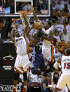 Charlotte Bobcats' Michael Kidd-Gilchrist (14) shoots, and is fouled by Miami Heat's Udonis Haslem, right, as Chris Bosh (1) defends during the first half in Game 2 of an opening-round NBA basketball playoff series, Wednesday, April 23, 2014, in Miami. (AP Photo/Lynne Sladky)