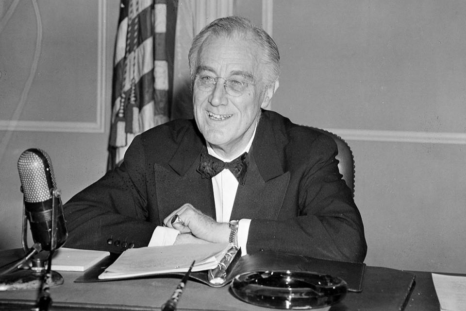 President Franklin D. Roosevelt takes his place before the microphone at the White House to give one of his famous 