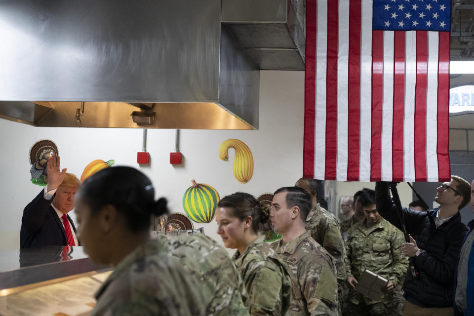 President Donald Trump, left, serves dinner during a surprise Thanksgiving Day visit to the troops, Thursday, Nov. 28, 2019, at Bagram Air Field, Afghanistan. (AP Photo/Alex Brandon)