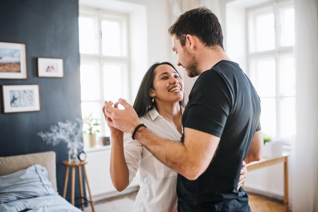 A young woman and man spending time together indoors.