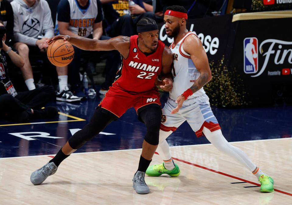 Jimmy Butler (22) drives against Bruce Brown.