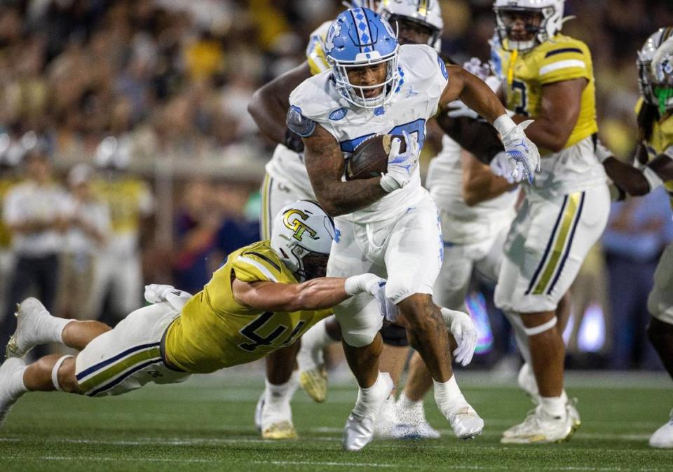 North Carolina’s Omarion Hampton (28) picks up 14-yards in the first quarter as Georgia Tech’s Malcolm Pugh (41) works to stop him on Saturday, October 28, 2023 at Bobby Dodd Stadium in Atlanta, Georgia.