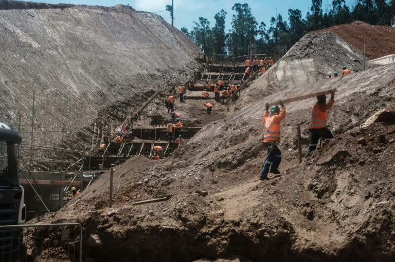 General view of workers at the rebuilding site next to the collapsed iron ore waste dam of Brazilian mining company Samarco, in Mariana, Minas Gerais State, Brazil, on October 26, 2016