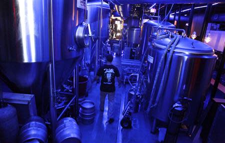Assistant brewer Kenny Stulyr works at Tequesta Brewing Co. in Tequesta, Florida April 2, 2014. REUTERS/Javier Galeano
